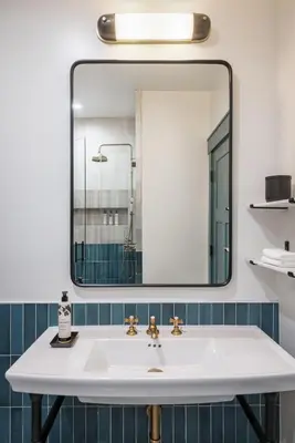 a bathroom with a white sink and a mirror at The Richland in Orange