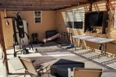 a room with a gym with a tv and chairs at Stylish 4 Bedroom Home Near Venice Beach with Backyard BBQ in Los Angeles