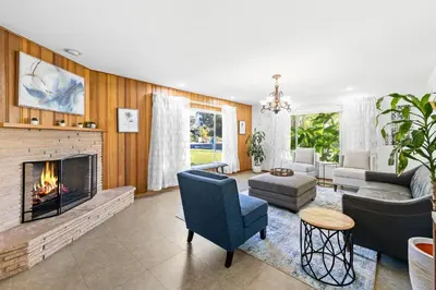 a living room with a fireplace and a couch at Spacious pool home in Pasadena in Pasadena