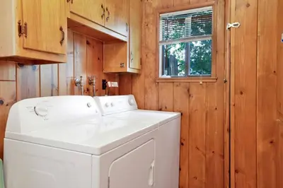 a white washer and dryer in a wooden laundry room at Pine Nest Relaxing Walk to Marina Cozy Chalet in Big Bear Lake