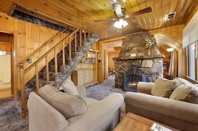 a living room with couches and a stone fireplace at Pine Nest Relaxing Walk to Marina Cozy Chalet in Big Bear Lake