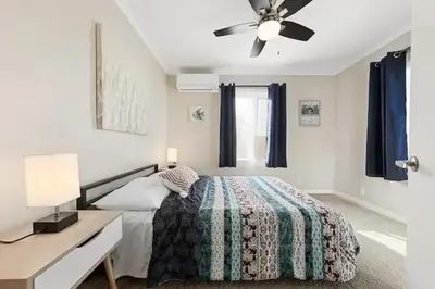 a bedroom with a bed and a ceiling fan at Spacious Centrally Located NEW 2 Bedroom Property! in Inglewood