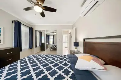 a bedroom with a bed and a ceiling fan at Spacious Centrally Located NEW 2 Bedroom Property! in Inglewood