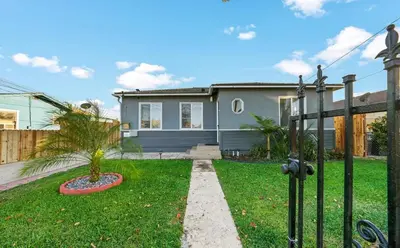 a house with a gate in a yard at Spacious Centrally Located NEW 2 Bedroom Property! in Inglewood