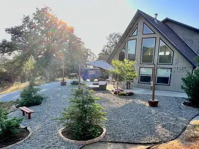 a house with trees and a bench in front of it at Modern House on 5 acr in Sequoia National Forest in Panorama Heights