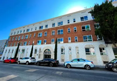 a large brick building with cars parked in front of it at Heart of Hollywood Apartment - 2Bed 2Bath in Los Angeles