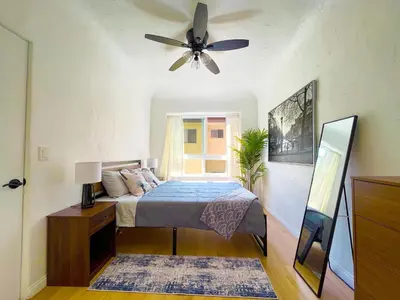 a bedroom with a bed and a ceiling fan at Heart of Hollywood Apartment - 2Bed 2Bath in Los Angeles