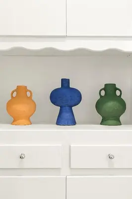three vases sitting on top of a white dresser at East Village Arts District, King Suite with Sofa Bed NRP23-01221 in Long Beach
