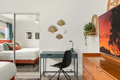 a bedroom with a desk and a bedroom with a bed at East Village Arts District, King Suite with Sofa Bed NRP23-01221 in Long Beach