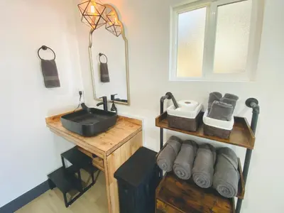a bathroom with a sink and a mirror at The Inspo Cabin with Stunning View in Running Springs