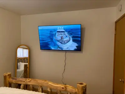 a flat screen tv hanging on a wall at Village and Lake Escape - Walk to the Lake and Village in Big Bear Lake
