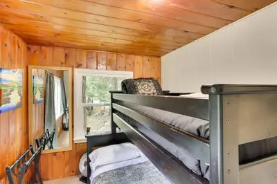 a bedroom with a bunk bed in a house at Pet-Friendly California Abode with Fenced-In Yard! in Crestline