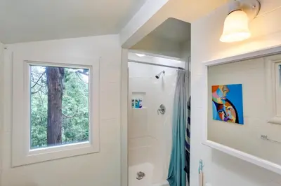 a bathroom with a shower and a window at Pet-Friendly California Abode with Fenced-In Yard! in Crestline