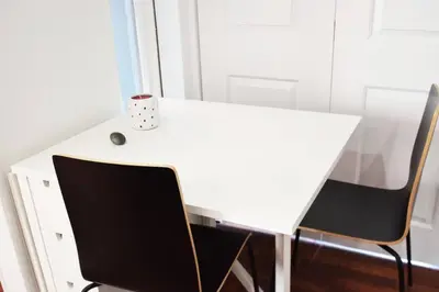 a white desk with two chairs and a cup on it at Villa by the Ocean in Venice Beach in Los Angeles