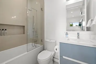 a bathroom with a toilet and a shower and a sink at The Palms Pad - 5 Min from Beach - Golf,Arcade,Sauna in Los Angeles