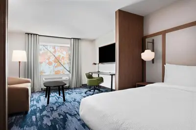 a hotel room with a bed and a desk at Fairfield by Marriott Inn & Suites Chino in Chino