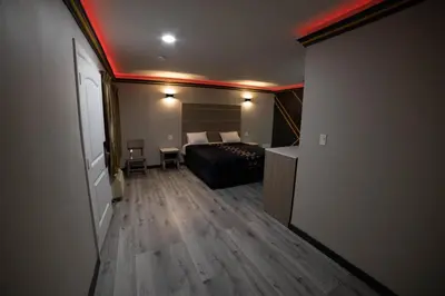 a hotel room with a bed and a red ceiling at Artesia Motor Inn in Bellflower