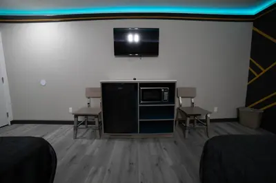 a room with a flat screen tv on the wall at Artesia Motor Inn in Bellflower