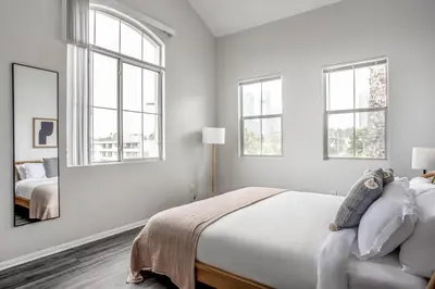 a white bedroom with a bed and a mirror at West LA 2br w rooftop courtyard LAX-1055 in Los Angeles