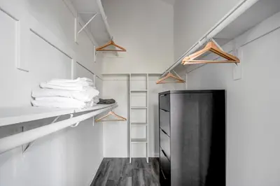 a walk in closet with white walls and a black door at West LA 2br w rooftop courtyard LAX-1055 in Los Angeles