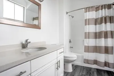 a bathroom with a sink and a toilet and a mirror at West LA 2br w rooftop courtyard LAX-1055 in Los Angeles