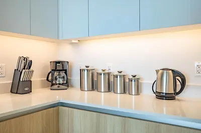 a kitchen counter with silver and black appliances on it at @ Marbella Lane - Sleek Corner Ocean View in Long Beach