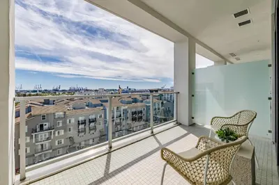a balcony with two chairs and a view of a city at @ Marbella Lane - Sleek Corner Ocean View in Long Beach