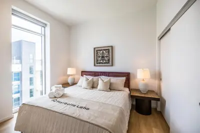 a bedroom with a large bed and a window at @ Marbella Lane - Sleek Corner Ocean View in Long Beach