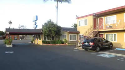 a car parked in a parking lot in front of a motel at Cloud 9 in Cypress