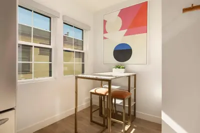 a small table in a room with windows at Downtown Culver City New Designer Lux 1 Bedroom in Los Angeles
