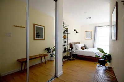 a room with a bed and a glass door leading to a bedroom at Ocean View Hot Tub Luxe House Steps to Sand in Hermosa Beach