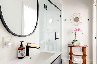 a bathroom with a large mirror and a white tub at Vibe on the Patio at a Modern Luxury Studio near LAX Beach in Los Angeles