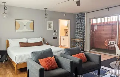 a bedroom with a bed and two chairs at LA Huge Mid Century Guesthouse Patio LAX Beach in Los Angeles