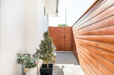 a hallway with a wooden fence and a christmas tree at LA Huge Mid Century Guesthouse Patio LAX Beach in Los Angeles