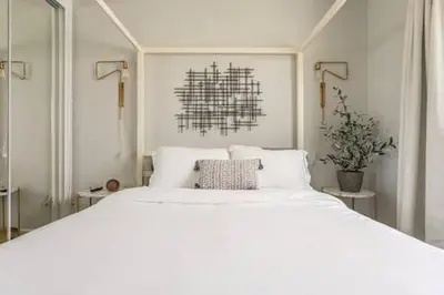 a white bedroom with a large white bed at Downtown Manhattan Beach 3 Bed Townhouse Parking in Manhattan Beach