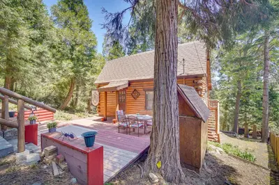 a cabin in the woods with a wooden deck at Crestline Area Vacation Rental Cabin with Decks! in Crestline