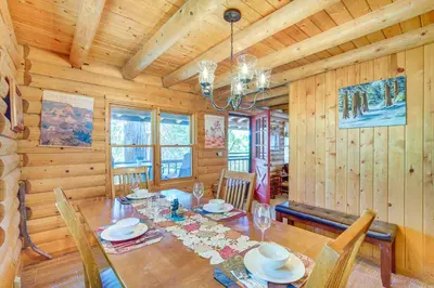 a dining room with a table and chairs in a cabin at Crestline Area Vacation Rental Cabin with Decks! in Crestline