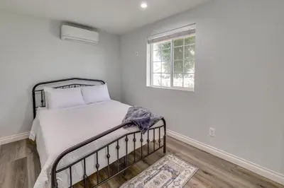 a bed in a white room with a window at Sleek San Fernando Studio about 14 Mi to Universal in San Fernando