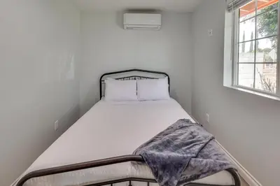 a small bed in a white room with a window at Sleek San Fernando Studio about 14 Mi to Universal in San Fernando