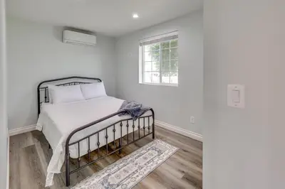 a white bedroom with a bed and a window at Sleek San Fernando Studio about 14 Mi to Universal in San Fernando