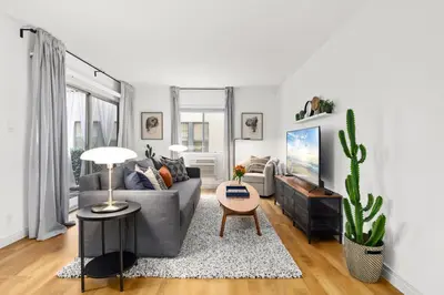 a living room with a gray couch and a cactus at Double King Suite with Patio Dining and Parking NRP21-00386 in Long Beach
