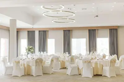 a banquet hall with white tables and white chairs at Doubletree By Hilton Pomona in Pomona