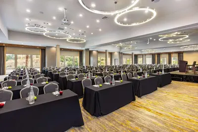 a conference room with rows of tables and chairs at Doubletree By Hilton Pomona in Pomona