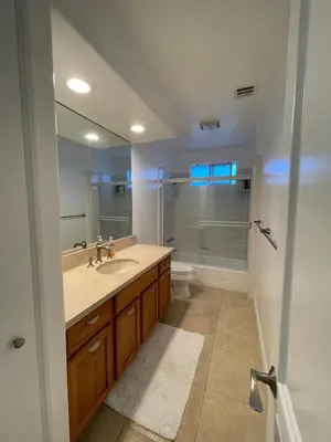 a bathroom with a sink and a toilet and a mirror at Charming Bright Traditional Home in Sherman Oaks in Sherman Oaks