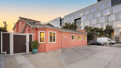 a small orange house in front of a building at Urban Jungle by AvantStay in Los Angeles