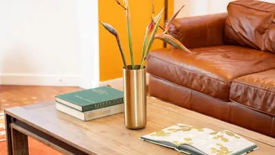 a vase sitting on a coffee table with books at Southwest by AvantStay in Los Angeles