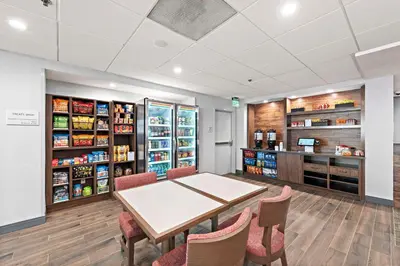 a dining room with a table and chairs at Hampton Inn Los Angeles Airport in Los Angeles
