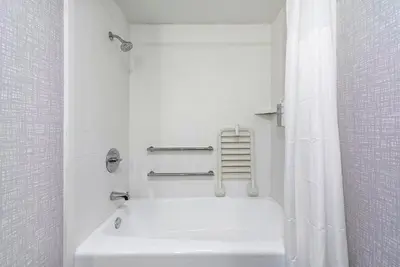 a white bathroom with a tub and a shower at Hampton Inn Los Angeles Airport in Los Angeles