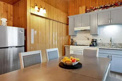 a kitchen with a table with a bowl of fruit on it at Sweet Retreat 1- Cozy Relaxing Resort Cabin in Big Bear Lake