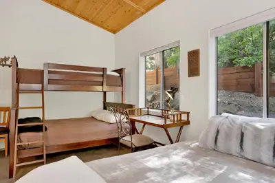 a bedroom with a bunk bed and a desk at Knickerbocker Retreat- Hot Tub- Game Tables in Big Bear Lake